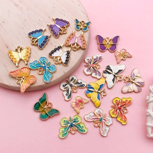 Detailed macro view of colorful enamel butterfly charms with golden metal edges for jewelry