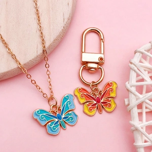 Charming enamel butterfly necklace and keychain set with intricate gold-plated details