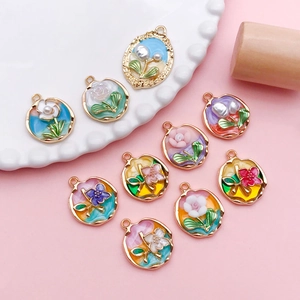 Macro view of colorful enamel tulip charms with imitation pearls for DIY jewelry making