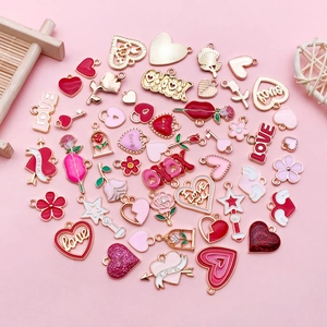 Macro shot of assorted pink heart and flower alloy charms for DIY jewelry making projects