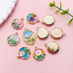 Macro detail of vintage tulip pendants with enamel flowers and gold metal frames