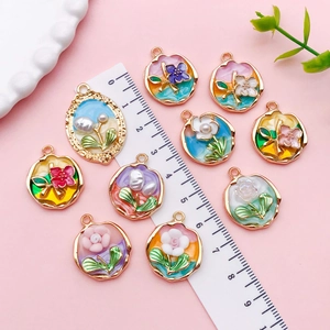 Macro detail of tulip flower charms showing golden alloy edges and pearl accents with ruler
