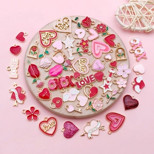 Detail of pink and red enamel heart, rose, and LOVE charms for DIY jewelry making