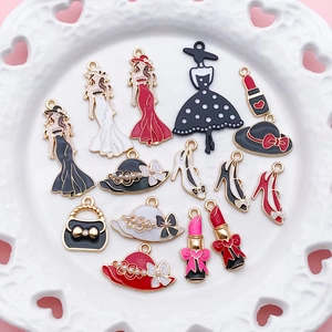 Detailed flat lay of colorful enamel fashion charms including high heels and lipstick