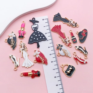 Detail of colorful enamel charms featuring dresses, lipstick and high heels for DIY crafts