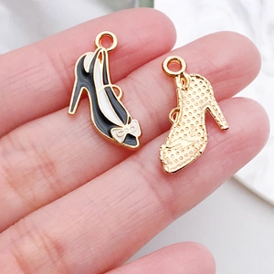 Detail of high heel charms with enamel bow and gold dotted texture for DIY jewelry