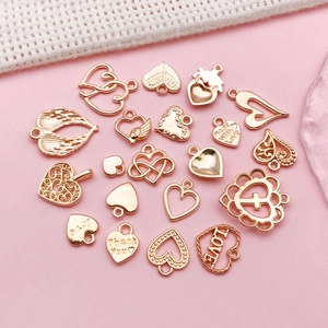 Macro view of rose gold heart and wing charms with Made With Love and Thank You engravings