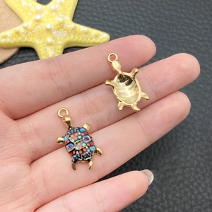 Detail of colorful mosaic sea turtle pendants for DIY jewelry making and crafts