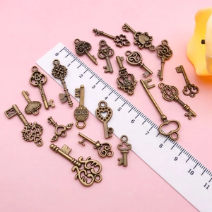 Close-up of vintage bronze alloy key charms for DIY jewelry making in assorted styles