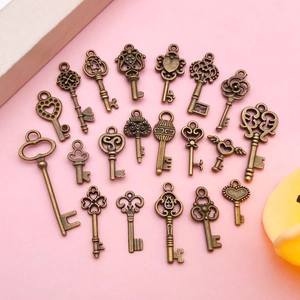 Flat lay of diverse antique bronze skeleton key charms for DIY jewelry making