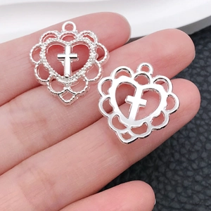 Detailed view of silver hollow heart cross pendants with textured and polished finishes