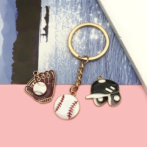 Golden baseball keychain set with enamel catcher glove, ball, and batting helmet charms