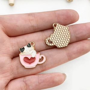Detail of cute cat in tea cup enamel charm with golden textured back for DIY jewelry