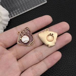Macro detail of enamel baseball glove charms showing front and back texture on a palm
