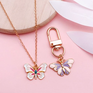 Conjunto de collar y llavero de mariposa en esmalte con acabado en oro rosa