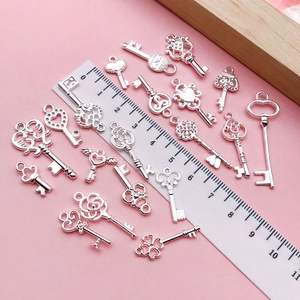 Collection of 18 vintage silver heart and wing key pendants for DIY jewelry crafting
