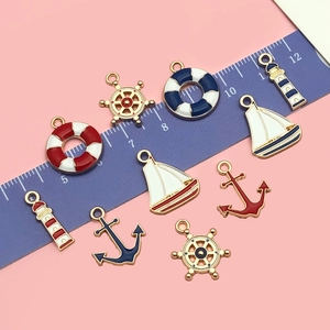 Detailed view of nautical alloy charms with ruler showing 1.5cm to 2.5cm size reference