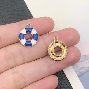 Detailed view of alloy lifebuoy nautical charm pendant with blue and white enamel