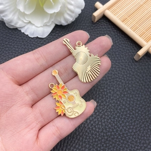 Macro view of sunflower guitar pendant with enamel finish and gold textured metal back