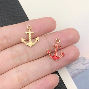 Detail of red and gold nautical anchor charms for DIY jewelry making accessories
