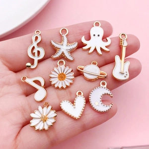 DIY gold alloy pendants with white enamel in moon, starfish, and heart shapes