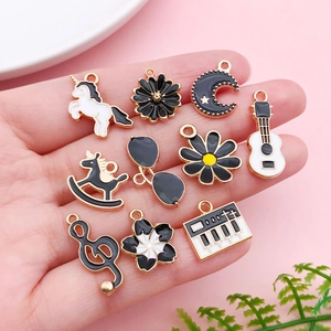 DIY black enamel alloy charms set featuring unicorn and musical note on a hand palm