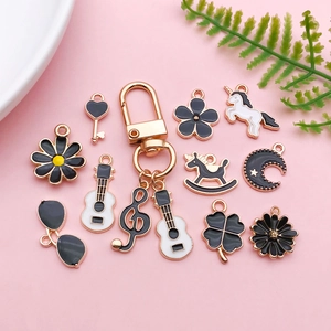 DIY black alloy oil drop charm collection including sunflower, guitar, and heart icons