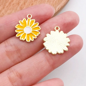 Macro detail of sunflower pendant showing enamel petals and textured metal back