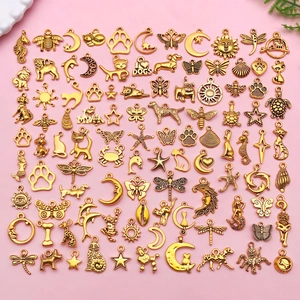 Mix of 70+ golden alloy charms with animal, ocean, and sun designs for DIY jewelry