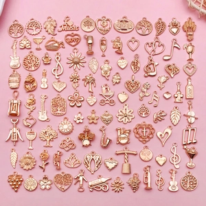Collection of rose gold alloy charms including musical instruments and floral patterns