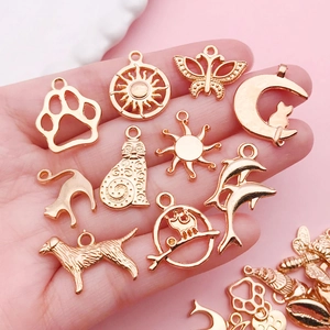 Detailed view of assorted gold alloy animal and sun pendants for DIY jewelry