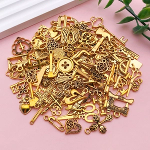 Mix of golden alloy charms including keys, hearts, and wings for DIY jewelry making