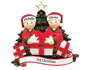 Detailed view of personalized resin Christmas ornaments with cute figures and gift box
