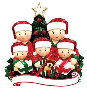 Detailed view of 5-member resin Christmas family ornament with red hats and gold star
