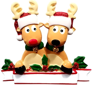Close-up of resin reindeer Christmas ornament with glitter hats and customizable white banner