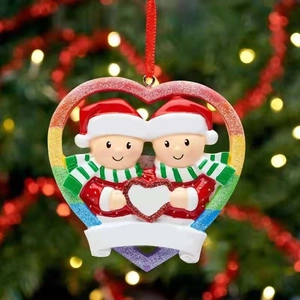 Macro shot of a colorful heart-shaped Christmas ornament with cute snowman couple and ribbons