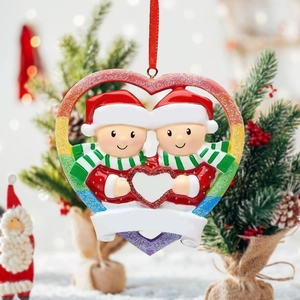 Rainbow heart Christmas ornament with two custom characters on snowy tree background