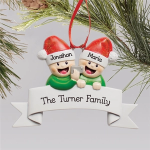 Customized Christmas ornament featuring two figures taking a selfie with names on hats