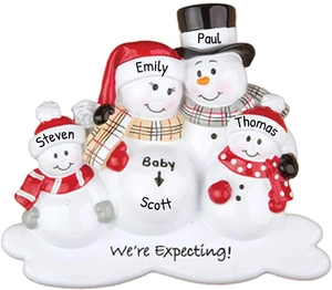 Macro detail of snowman family Christmas ornament with personalized names and expecting text