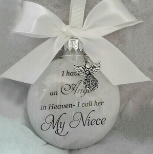 Feather-filled memorial plastic ball with white bow and silver angel charm pendant