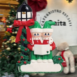 Close-up of two Christmas elves by a street lamp with a white blank for personalization