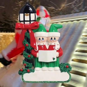 Detail of resin snowman carolers under a streetlamp for Christmas tree decoration