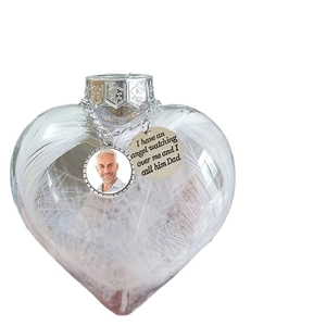 Memorial heart ornament with white feathers, photo frame, and engraved message charm