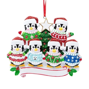 Detail of Christmas tree ornament with 6 cute penguins in colorful knitted sweaters