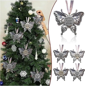 Detail of silver angel wing butterfly Christmas ornaments with memorial inscriptions