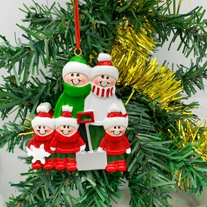 Customizable resin family of five Christmas sled ornament hanging on a festive tree