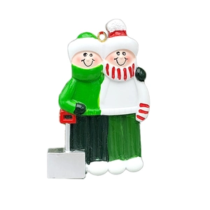 Detailed view of hand-painted resin Christmas ornament featuring two cozy cartoon figures