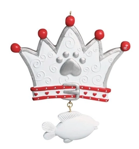 Macro detail of crown shaped cat ornament with silver paw print and fish pendant