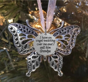 Close-up of angel wing butterfly memorial pendant with Grandpa engraving on Christmas tree
