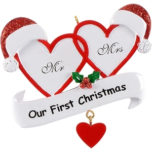 Macro detail of Mr & Mrs heart Christmas ornament with red hats and glittery finish